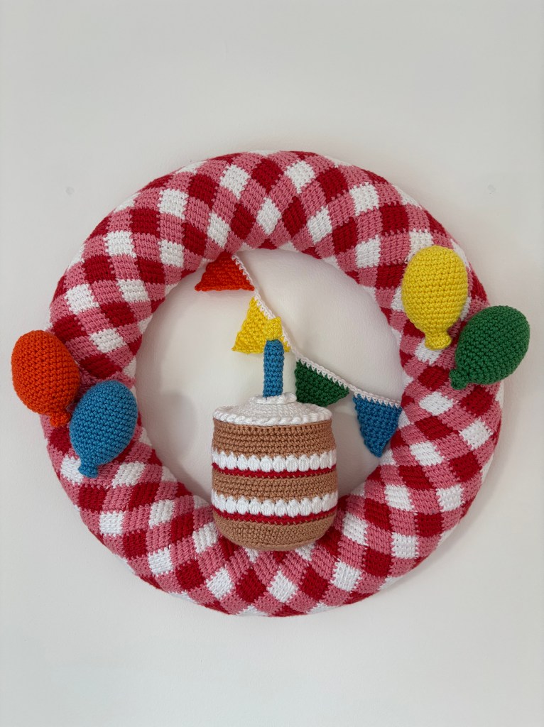 Image shows the Let's Celebrate wreath a crochet collaboration between Lindsay Weston from Making Stitches & Eleonora Tully from Coastal Crochet