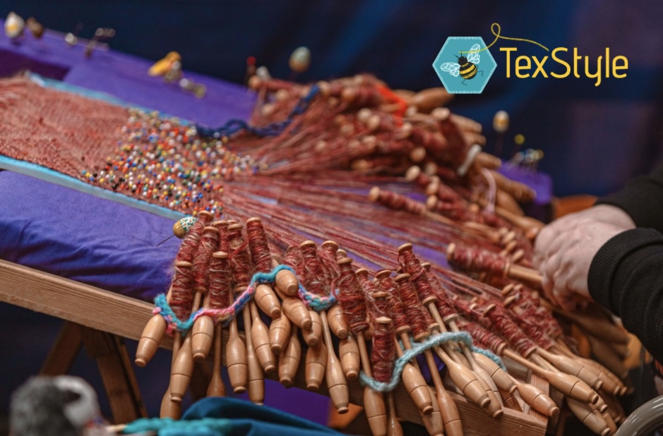Image shows a close up of someone lacemaking with the Texstyle logo overlaid over the top of the photo